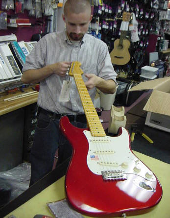 Guitar Tech Nick Winnard Checking the Neck on a Fender Eric Johnson Strat